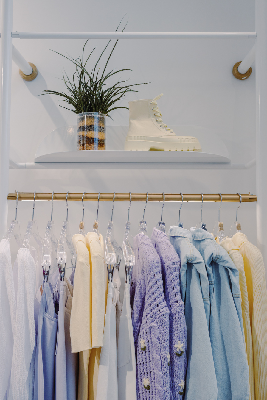 White and Purple Clothes Hanging on White Wooden Rack